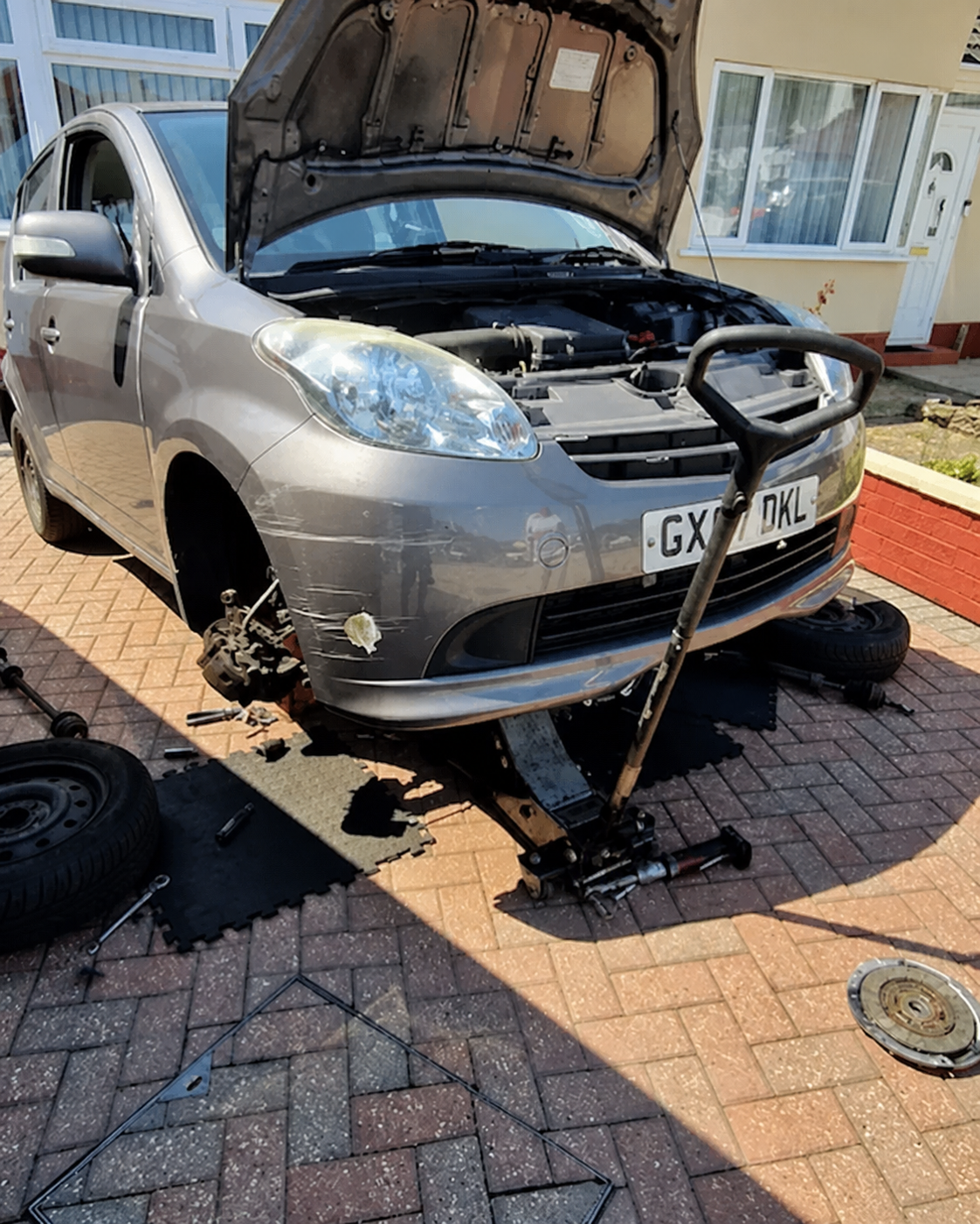 Mobile mechanic working on a car at a customer address in Southampton